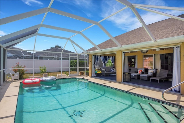 view of pool with a fenced in pool, glass enclosure, fence, a patio area, and outdoor lounge area