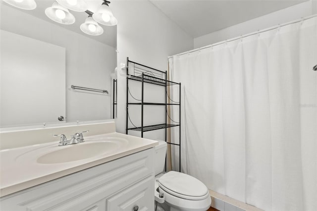 bathroom with toilet, curtained shower, and vanity