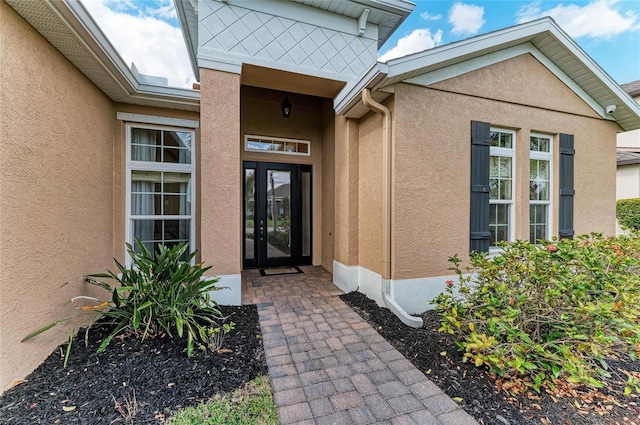 property entrance with stucco siding