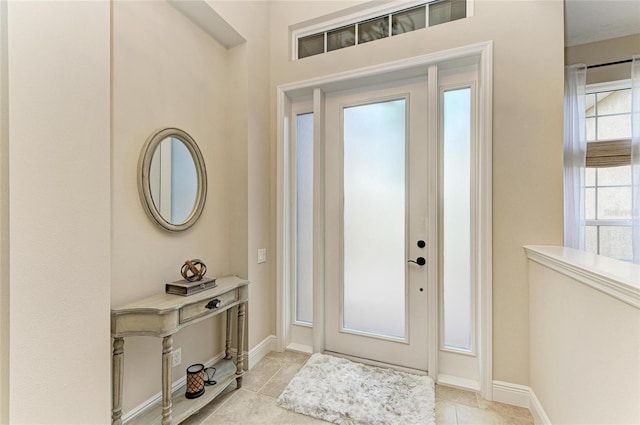 entrance foyer with baseboards and light tile patterned floors