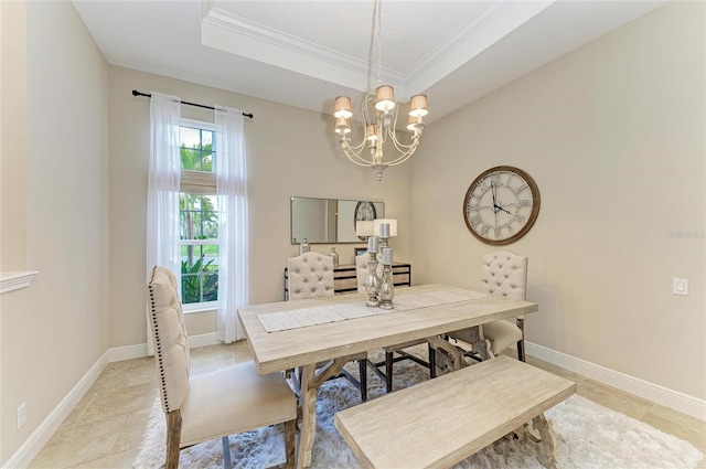 dining space with a raised ceiling, ornamental molding, light tile patterned flooring, a chandelier, and baseboards