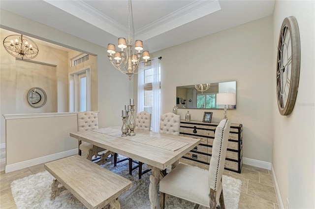 dining room featuring baseboards, a raised ceiling, a notable chandelier, and ornamental molding