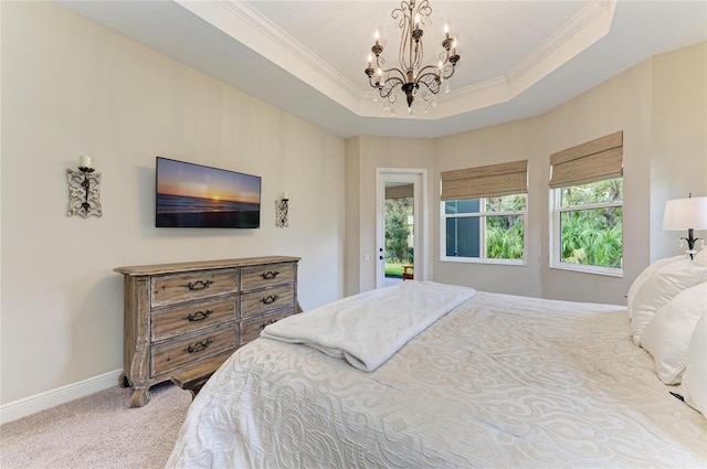 bedroom featuring carpet floors, a raised ceiling, ornamental molding, and baseboards