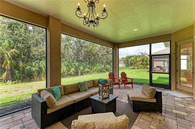 sunroom / solarium featuring a notable chandelier