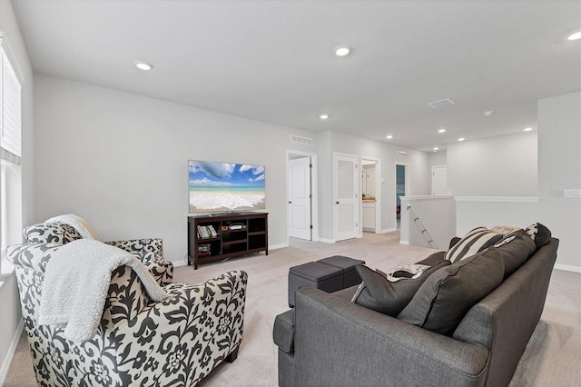 living room with baseboards, recessed lighting, visible vents, and light colored carpet