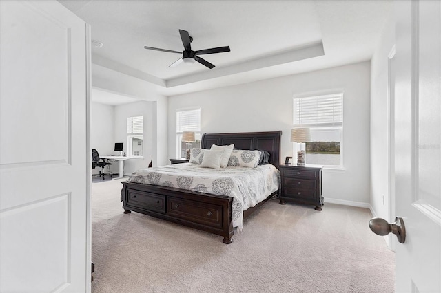 bedroom featuring carpet, baseboards, and a raised ceiling