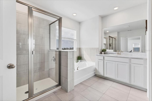 bathroom with a garden tub, tile patterned flooring, recessed lighting, vanity, and a shower stall