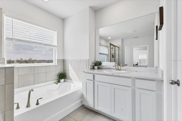 bathroom with a stall shower, vanity, a bath, and tile patterned floors