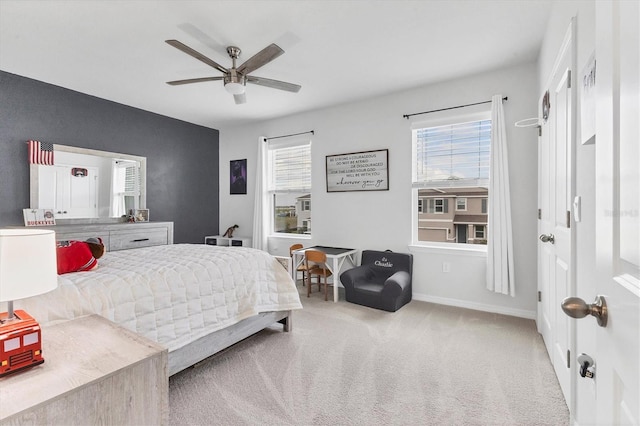 carpeted bedroom featuring ceiling fan and baseboards