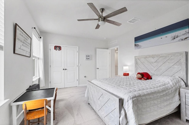 carpeted bedroom featuring ceiling fan and visible vents