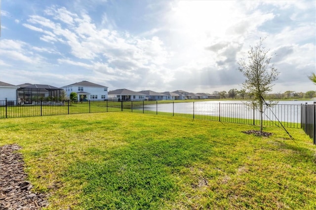 view of yard featuring fence and a residential view