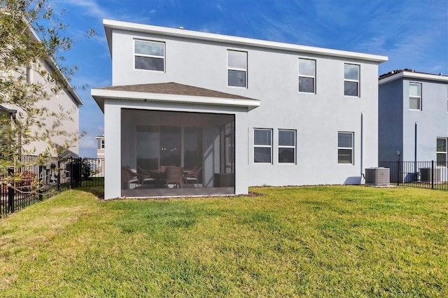 back of house featuring a fenced backyard, central AC, a sunroom, a lawn, and stucco siding