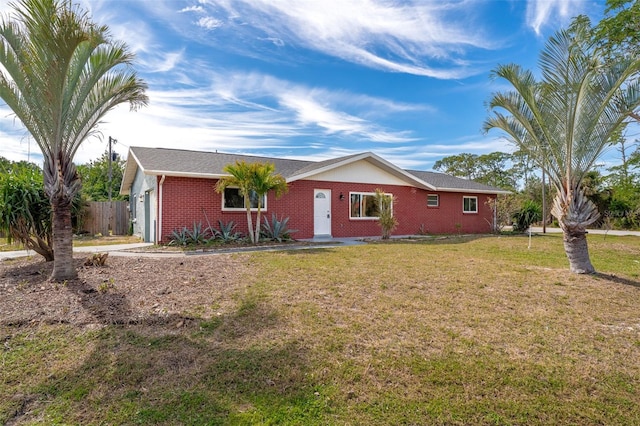 single story home with brick siding, a front yard, and fence