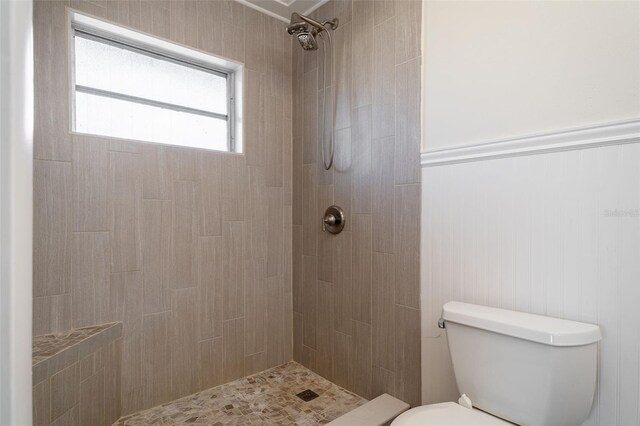 bathroom with tiled shower and toilet