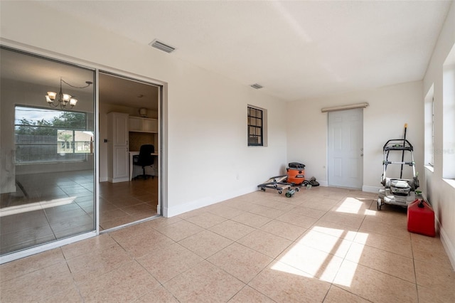 interior space with baseboards, visible vents, and an inviting chandelier