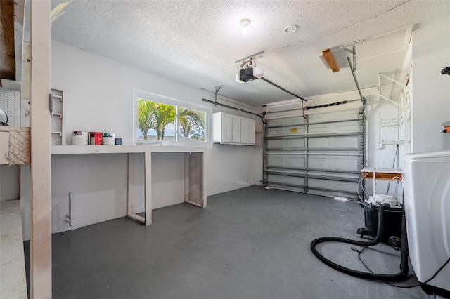 garage with a garage door opener and washer / dryer