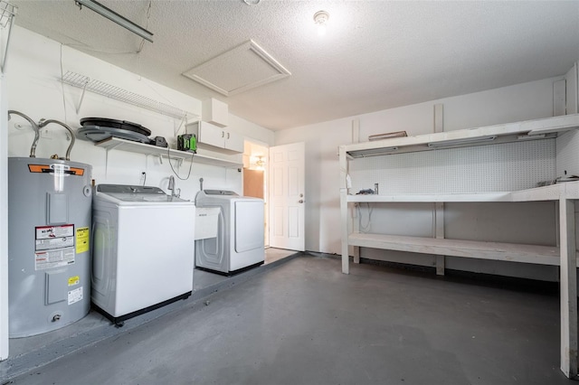 basement with water heater, a textured ceiling, and independent washer and dryer