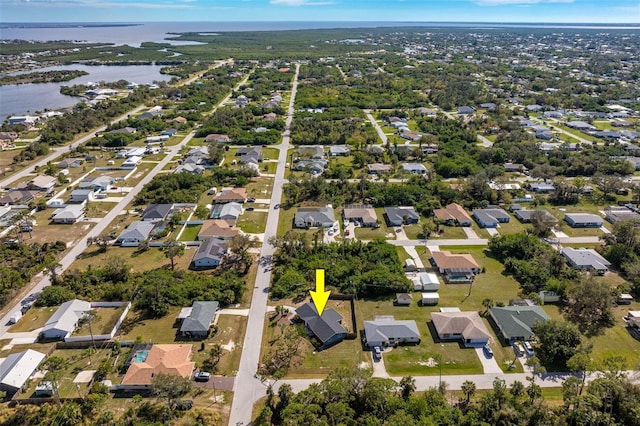 drone / aerial view featuring a residential view and a water view