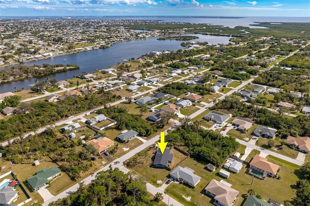 drone / aerial view featuring a water view and a residential view