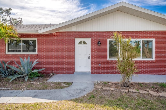 property entrance with brick siding