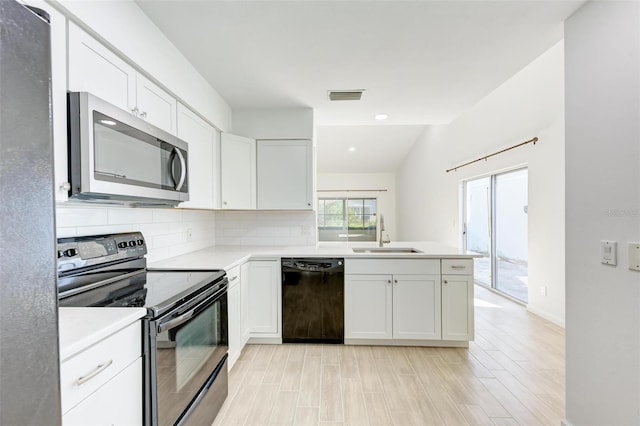 kitchen with visible vents, white cabinets, a sink, black appliances, and backsplash