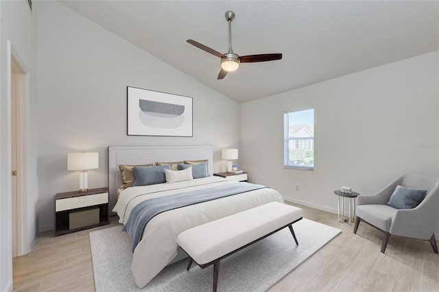 bedroom with light wood-style floors, vaulted ceiling, baseboards, and ceiling fan