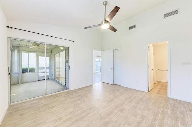 unfurnished room with ceiling fan, baseboards, visible vents, and light wood-style floors