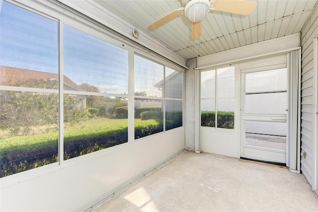 unfurnished sunroom with a ceiling fan