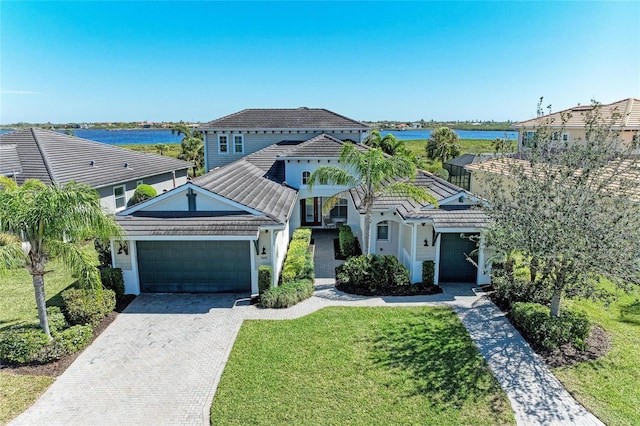5602 Tidewater Preserve Blvd, Bradenton, FL 34208 - view of front of house with an attached garage, driveway, a tile roof, and a water view
