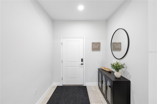 doorway featuring baseboards