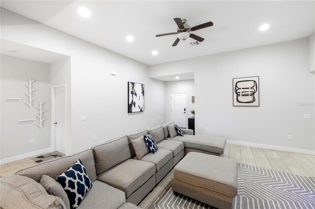 living room featuring ceiling fan, baseboards, and recessed lighting