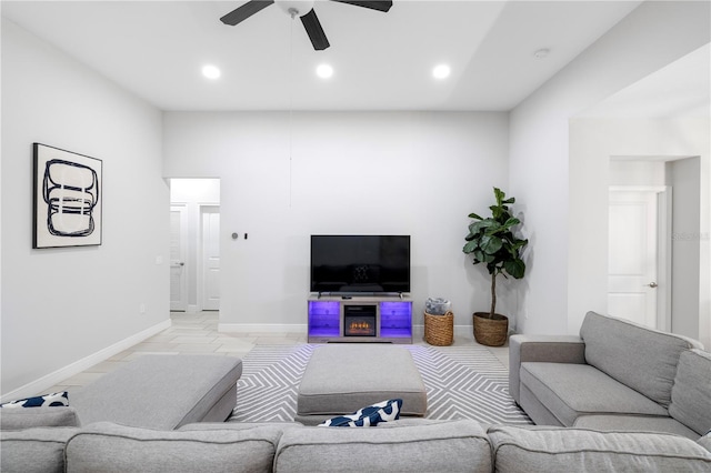 living area with ceiling fan, baseboards, and recessed lighting