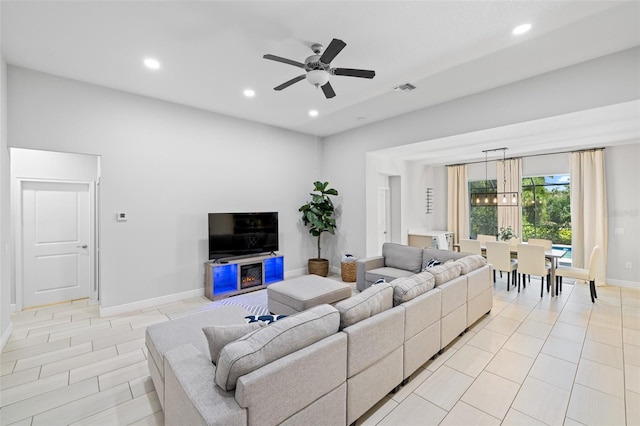 living room with baseboards, ceiling fan, visible vents, and recessed lighting