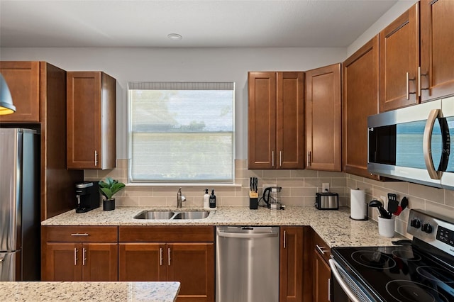 kitchen with stainless steel appliances, a sink, and decorative backsplash