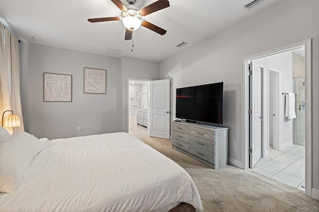 bedroom with light carpet, connected bathroom, visible vents, and baseboards