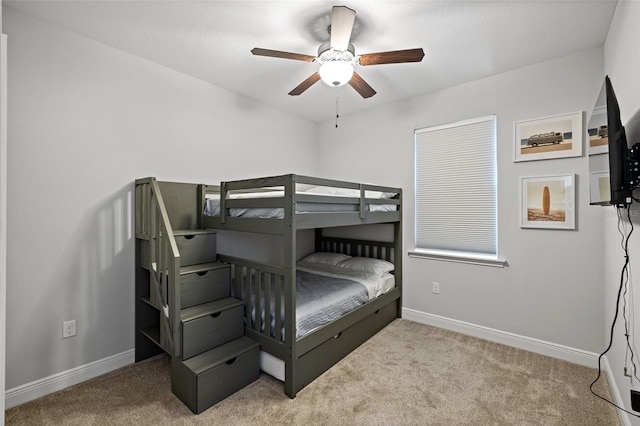 bedroom featuring carpet, a ceiling fan, and baseboards