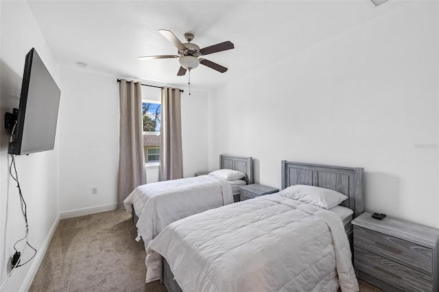 carpeted bedroom with a ceiling fan and baseboards