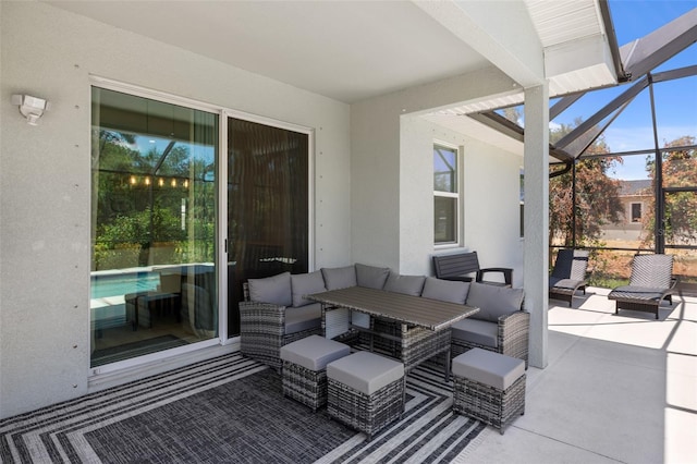 view of patio / terrace with glass enclosure and an outdoor living space