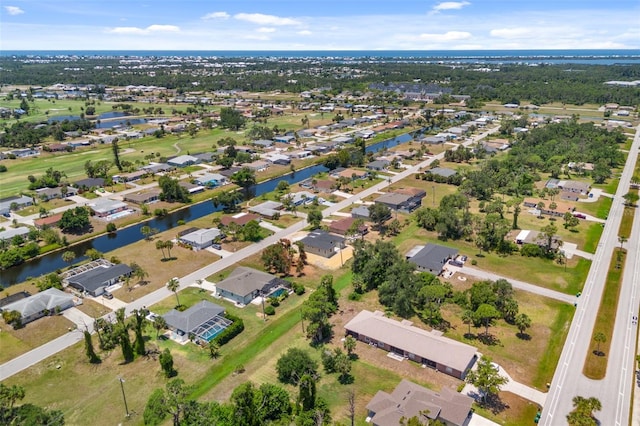 birds eye view of property featuring a residential view and a water view