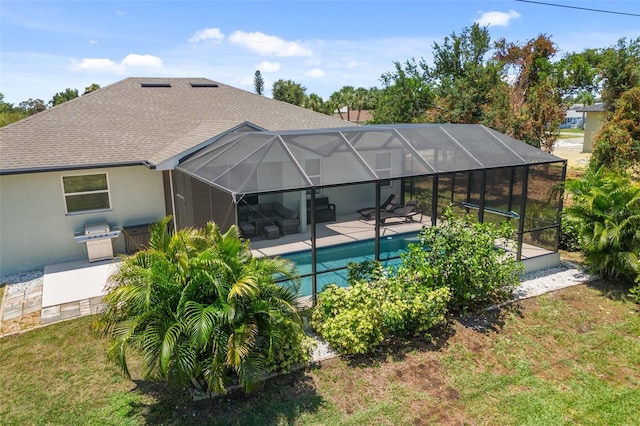 back of property featuring a lanai, roof with shingles, a patio, and stucco siding