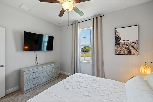 carpeted bedroom featuring visible vents, baseboards, and a ceiling fan