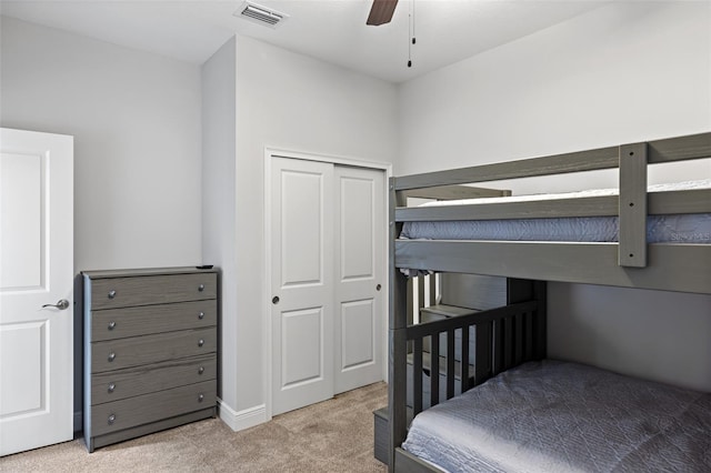 bedroom with ceiling fan, a closet, carpet, and visible vents