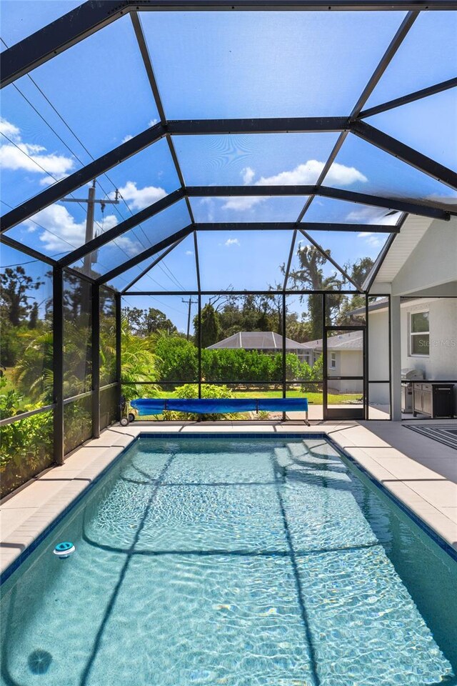 pool featuring a lanai and a patio