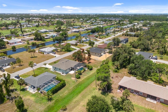 drone / aerial view with a water view and a residential view