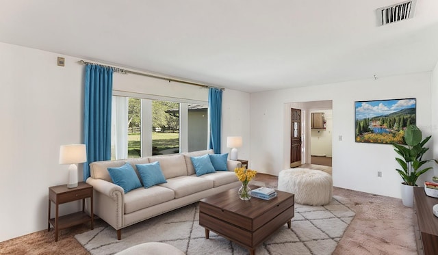 living room with light carpet and visible vents