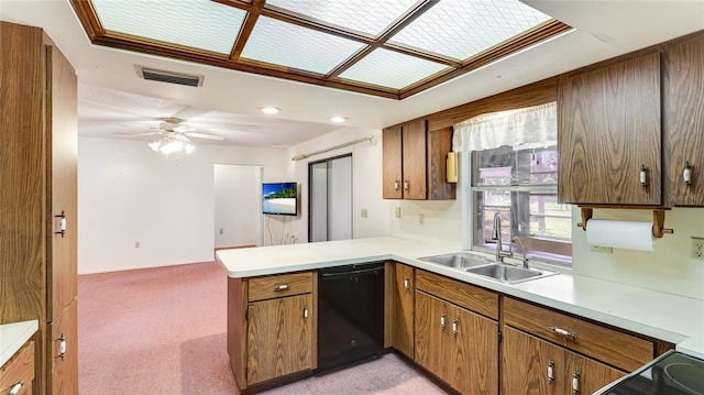 kitchen with black dishwasher, visible vents, a peninsula, light countertops, and a sink