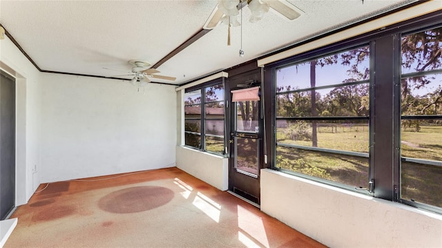 unfurnished sunroom with a ceiling fan