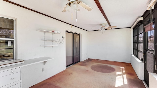 unfurnished sunroom with ceiling fan