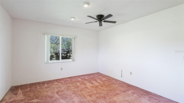 carpeted empty room featuring a ceiling fan and a textured ceiling