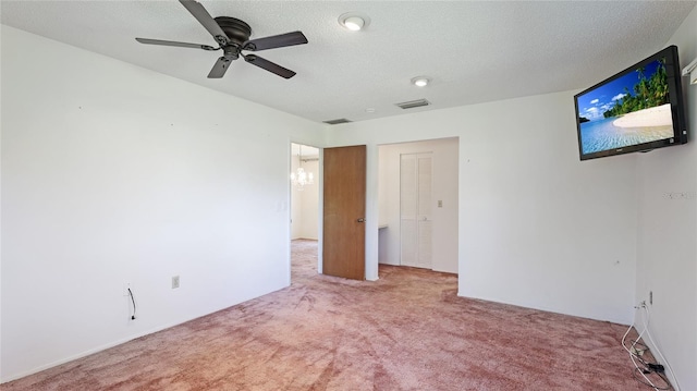 unfurnished bedroom with carpet floors, visible vents, and a textured ceiling